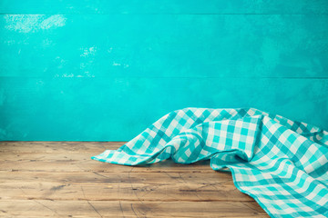 Empty wooden table with tablecloth over blue rustic  background