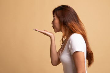 Beautiful young Asian woman blow a kiss.