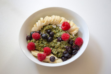 Matcha  Oatmeal porridge with ripe berries and banana