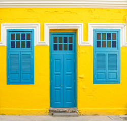 Blue door and windows on yellow wall