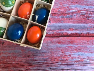 Colorful easter eggs on painted vintage wooden background. Concept for easter and card.