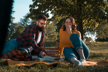 Beautiful happy young couple enjoying their time together on a picnic