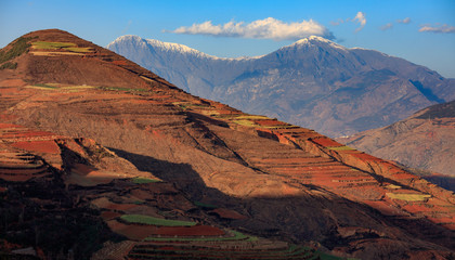Dongchuan Colored Red Earth Terraces - Red Soil, Green Grass, Layered Terraces in Yunnan Province, China. Chinese Countryside, Agriculture, Exotic Unique Landscape. Farmland, Agriculture
