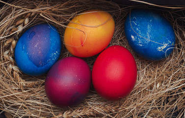 Fototapeta na wymiar Multi-colored chicken eggs lie on the hay. Easter.
