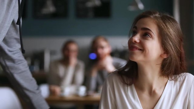 Confident african man getting acquainted with caucasian woman in cafe