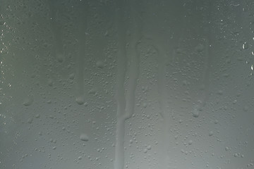 wet glass background condensate / abstract rain, drops texture on transparent glass