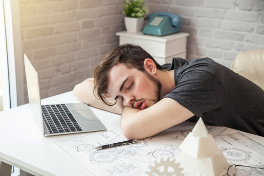 Man designers sleeping because of fatigue from work.