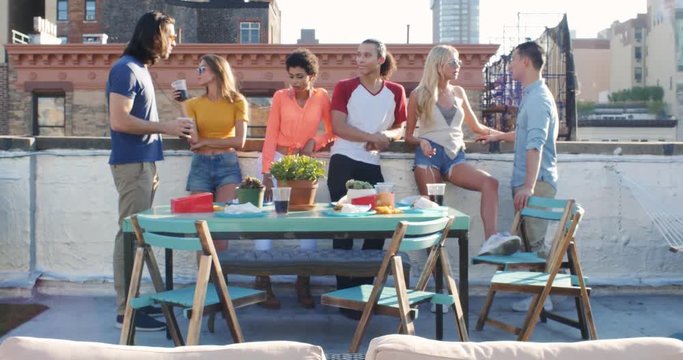 Group of friends making party on the rooftop in New york city