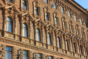 Classical building facade architecture of old historical ornamental house with beige colored walls 