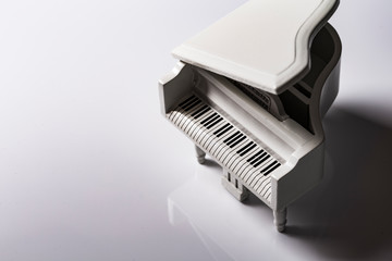 White tiny toy piano music sound on a white background