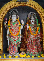 marble stone carved Indian Hindu God Vishnu and Goddess Lakshmi statues in a temple
