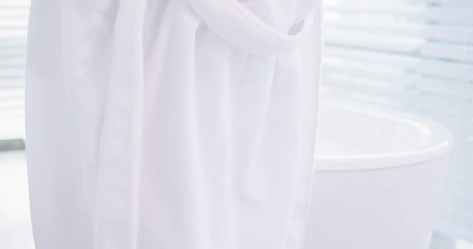young woman take off bathrobe