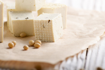 Soy Bean curd tofu on parchment paper Non-dairy alternative substitute for cheese