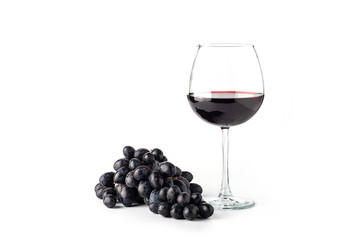 Red wine in a glass with grapes on a white background