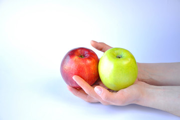 Fototapeta na wymiar man holds in both hands two apples red and green
