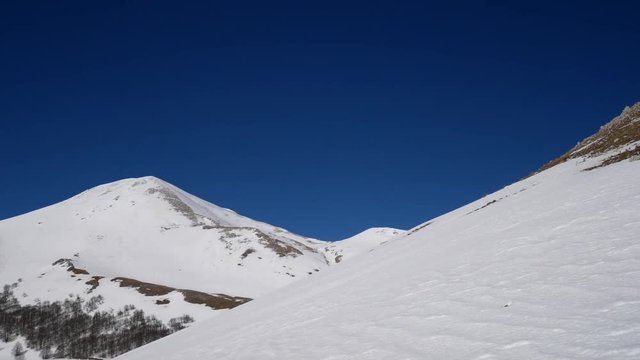 Campo dell'esule (Field of the exile), Campo dell'arco (field of the arch). Snow covered plateau with blue sky. Landscape of Matese Mountain National Park. Matese Lake, Caserta, Italy