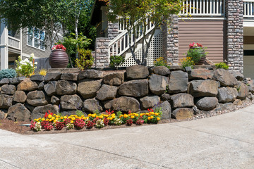 House Front Yard Landscaping with Rock Retaining Wall - 264796327