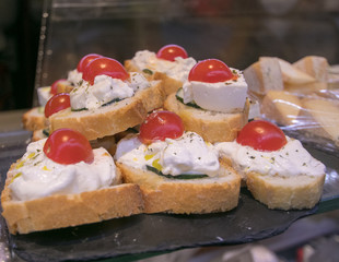 Mini sandwiches food set pattern. Burrata and Mozzarella Brushetta or authentic traditional spanish tapas for lunch table. Delicious snack, appetizer, antipasti on San Miguel Market Madrid. Top view