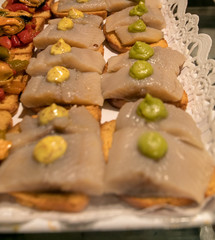 Cod bruschetta, tapas, pintxos, in white background in San Miguel Market, Madrid