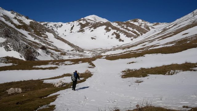 Matese Lake, Campania, Italy - february 2 2019: snowshoeing on snow covered plateau with blue sky. Matese Mounts landscape, Campo dell'esule (Field of the exile), Campo dell'arco (field of the arch)