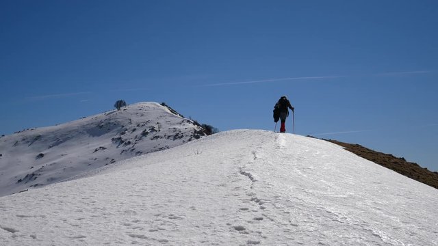 Matese Lake, Campania, Italy - february 2 2019: snowshoeing on snow covered plateau with blue sky. Matese Mounts landscape, Campo dell'esule (Field of the exile), Campo dell'arco (field of the arch)