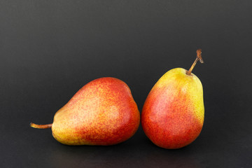 Contrast composition of ripe pears on a dark background