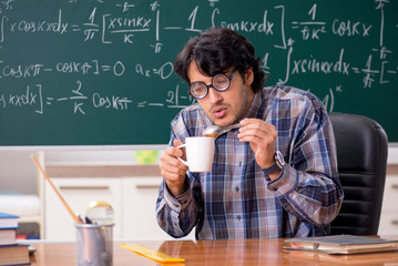 Funny male math teacher in the classroom 