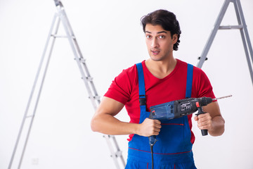 Young handsome contractor working indoors 