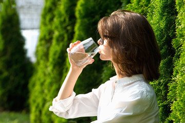 Close up portrait of girl drinks water.