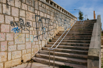 Staircase with graphite on the stone walls, access beach in promenade in Figueira da Foz, Portugal