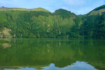 Beautiful green landscape view in colored green water of the Sete Cidades Lagoon in São Miguel island in the Azores