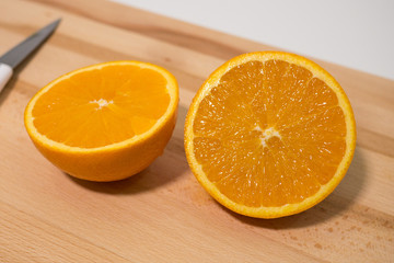 Sliced orange on wooden board