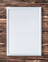 Empty frame on dark wooden background