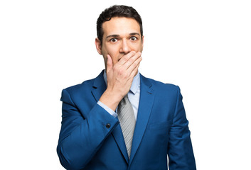 Funny businessman is covering his mouth with hands. Isolated on white background.