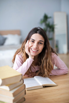 Girl Student Reads Books At Home.