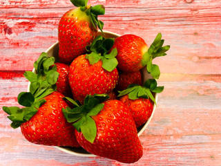 Fresh, juicy strawberries on wooden background.