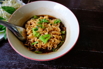 Noodle Soup with pork meat and vegetable on Wood Background. delicious Healthy Dish and Diet Food
