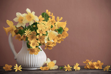 Still life with yellow spring flowers in jug