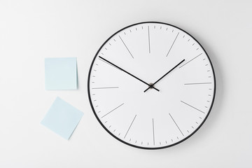 Round wall clock and blue stickers on white