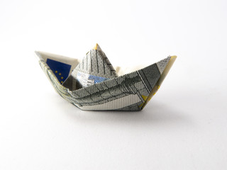 Obraz premium Single origami boat made of five euro note isolated on white background