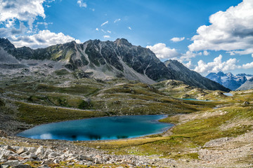 Fototapeta na wymiar Beautiful blue mountain lake, on the sides of the mountains rise to the height. Closer shot