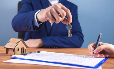 agent gives the keys to the home buyer