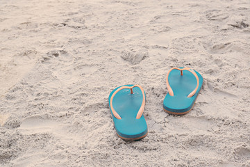 Fototapeta na wymiar Summer vacation concept. Flip flops on a sandy ocean beach