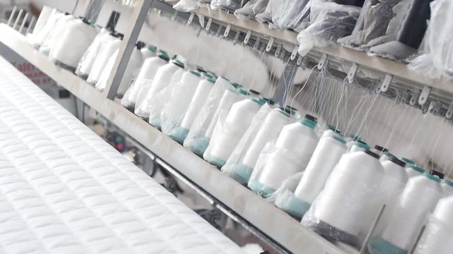 Process of quilting white mattress blanket on automatic loom