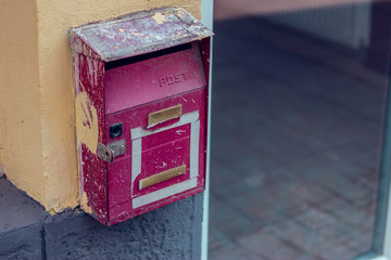 Small metal old mail box placed on a home exterior – Vintage and retro way of receiving letters, correspondence and news