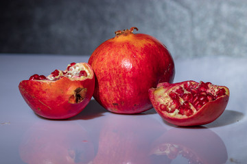 ripe pomegranate with reflection on the glass