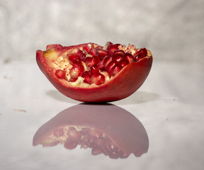 ripe pomegranate with reflection on the glass