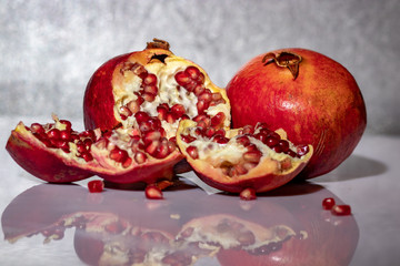 ripe pomegranate with reflection on the glass