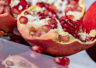 ripe pomegranate with reflection on the glass