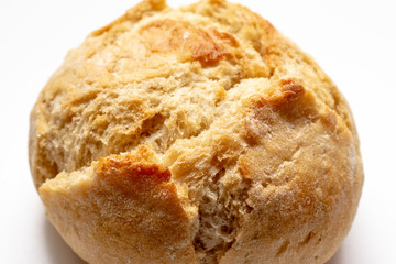 Baked wheat bun with golden crust on white background, bakery and grocery concept